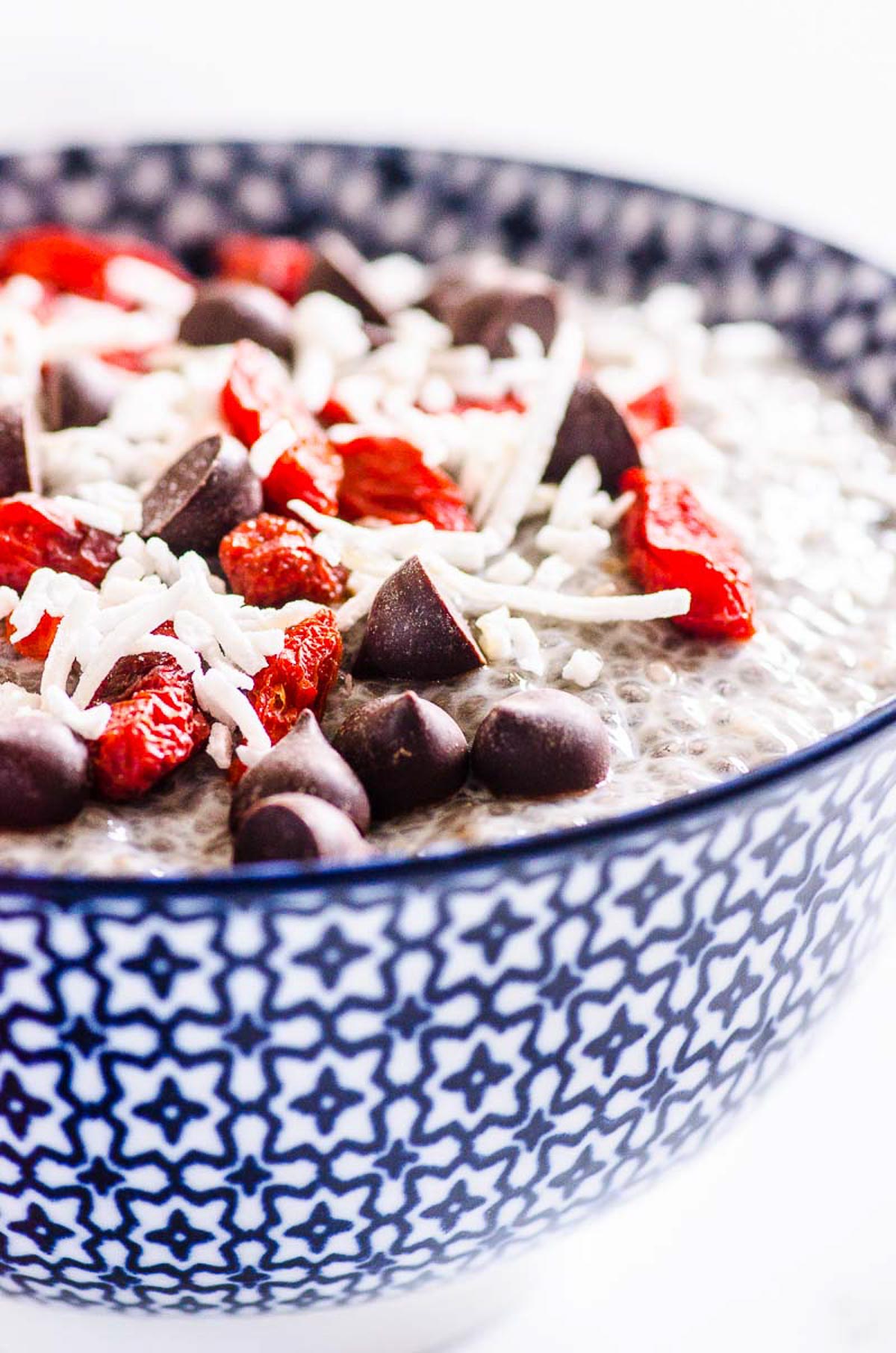 Chia seed pudding in blue and white bowl with toppings.