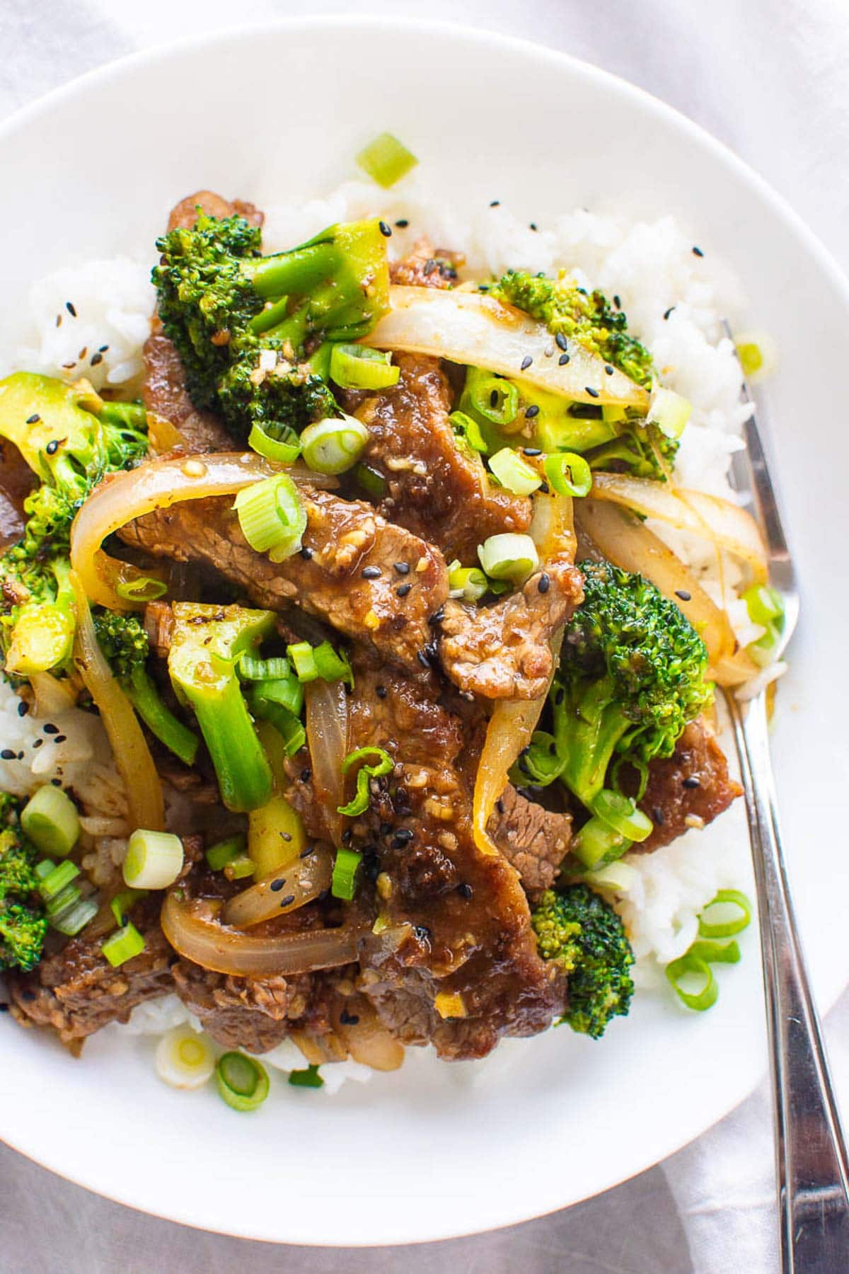 Healthy beef and broccoli with rice on a plate with fork.