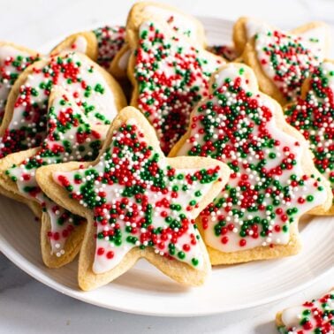 Decorated almond flour sugar cookies on a plate for serving.