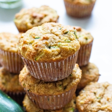 Three almond flour zucchini muffins stacked on top of each other.