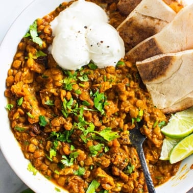 green lentil recipe with pita and sour cream in a bowl