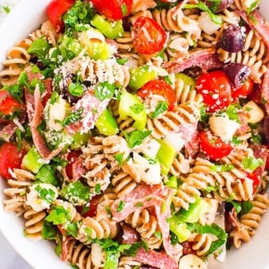 Italian pasta salad with tomatoes, olives, cheese and Italian dressing.