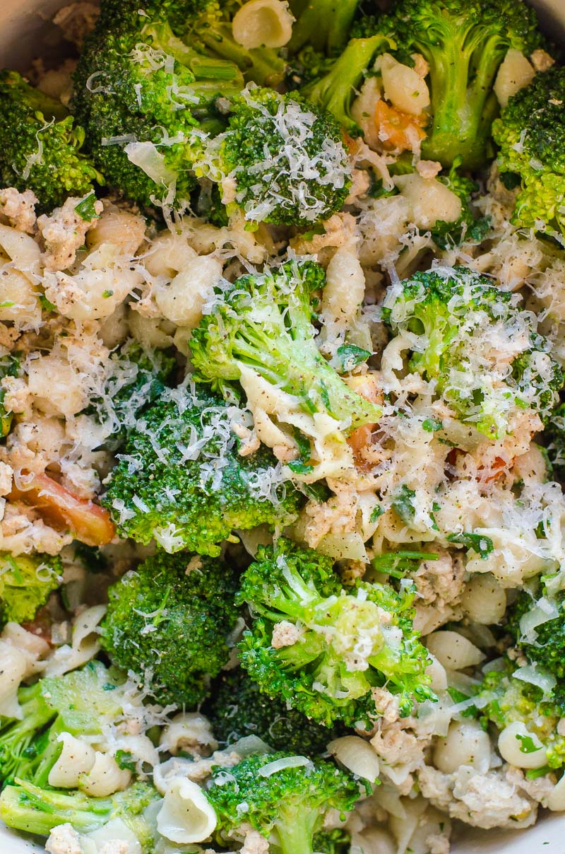 Close up of ground turkey, broccoli, pasta and parmesan cheese.