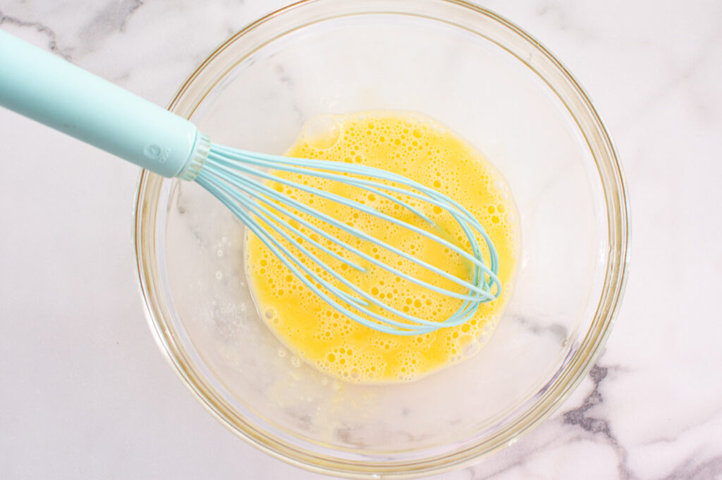 whisking egg for muffins in a bowl