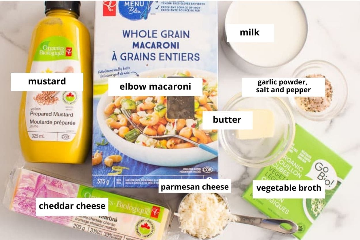 Elbow macaroni, milk, butter, parmesan cheese, cheddar cheese, broth, mustard, garlic powder, salt and pepper.