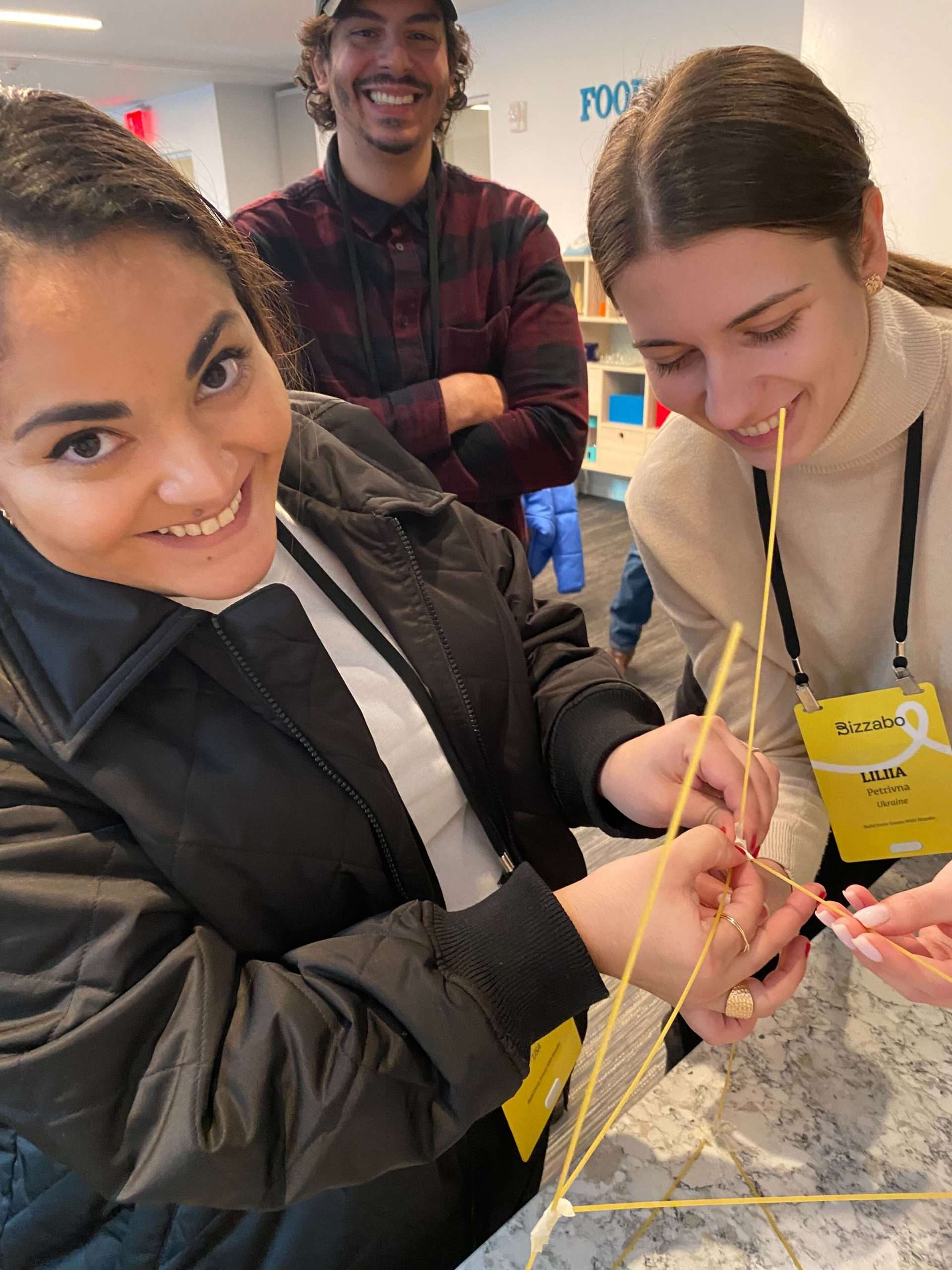 image of three Bizzabo employees taking on the spaghetti challenge at our GTMKO