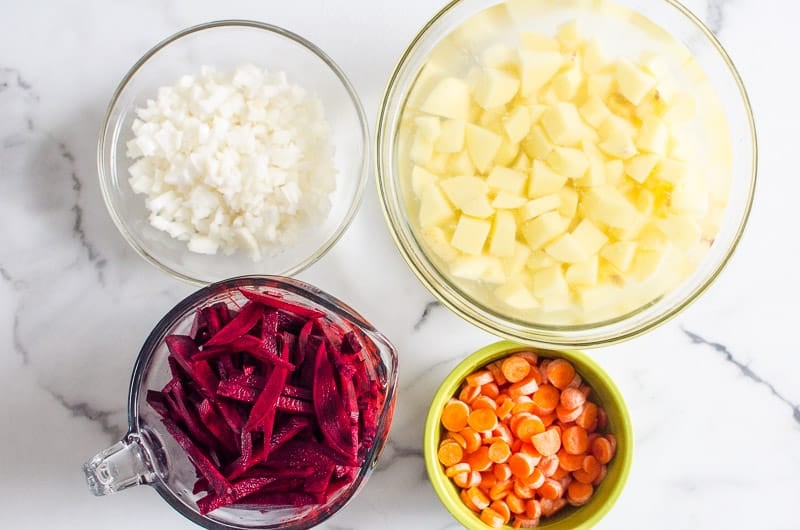 Sliced and diced beets, onions, carrots and potatoes.